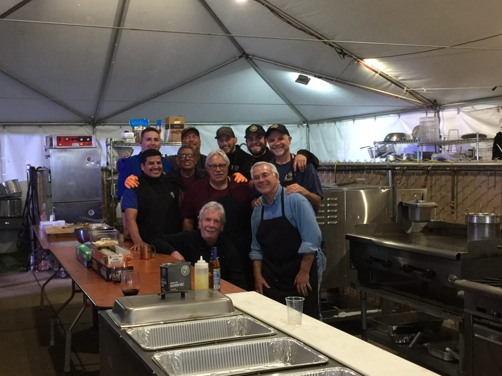 The Paisan’s catering crew gathered in the kitchen tent at an event